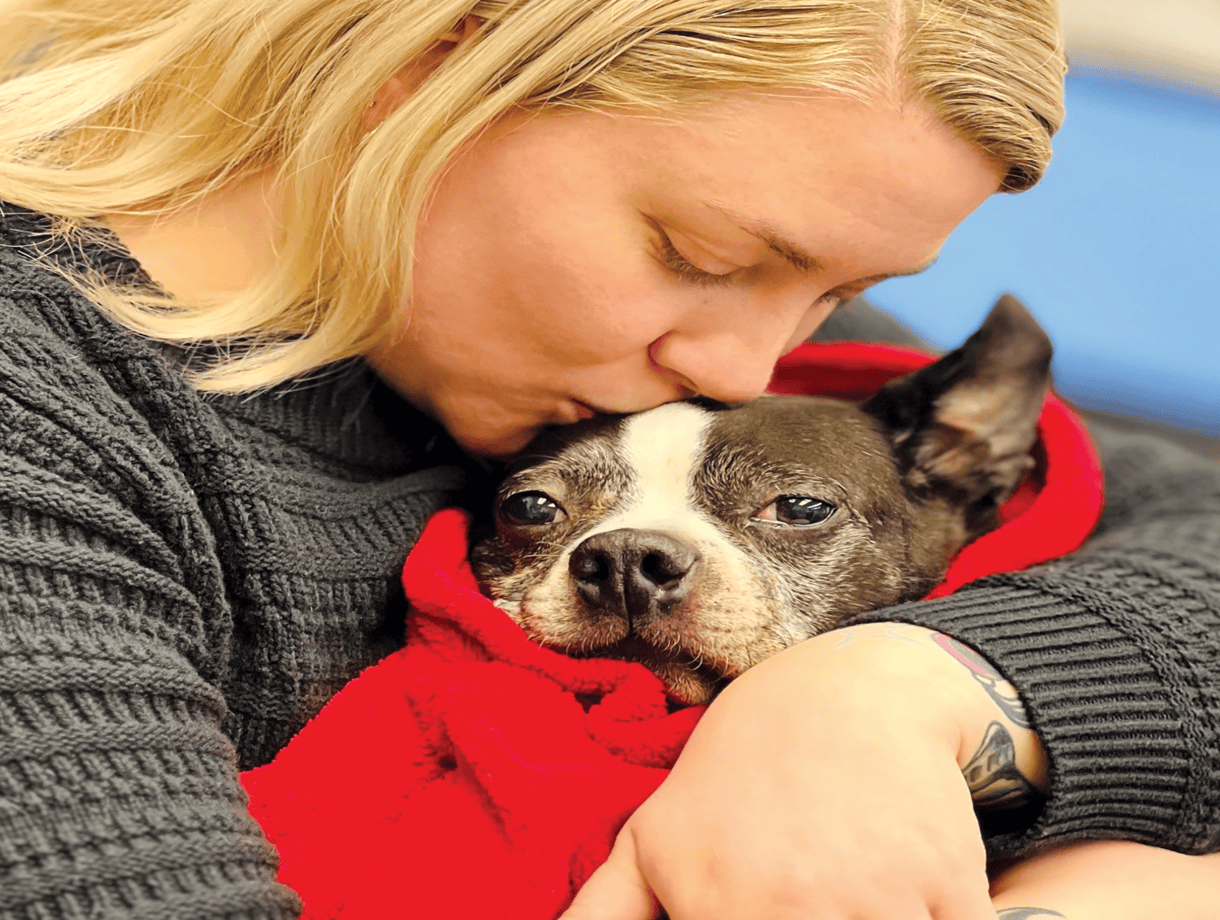woman kissing dog